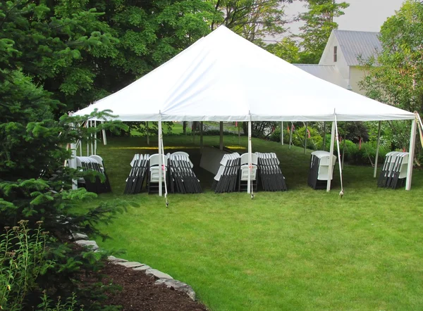 White frame tent set up on green lawn — Tents For Rent & Party Supply